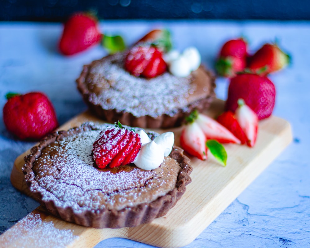 brown cupcake with strawberry on top