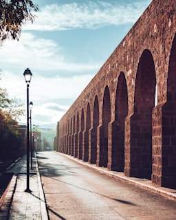 brown brick wall under blue sky during daytime