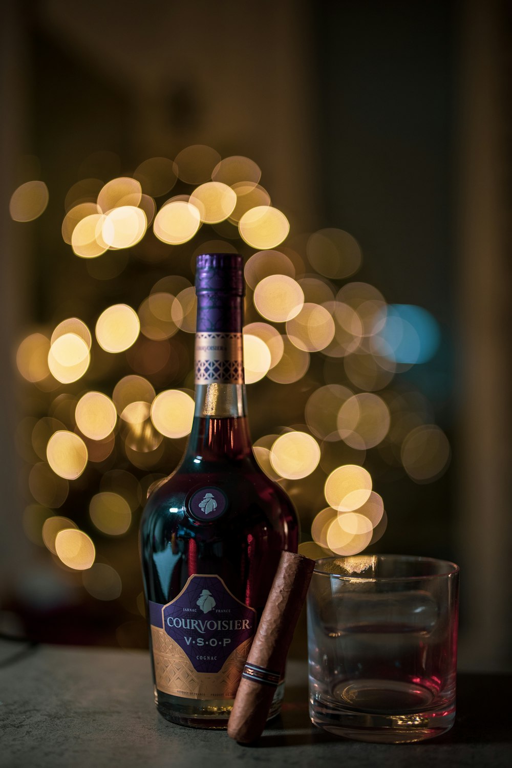 selective focus photography of red wine bottle beside clear drinking glass