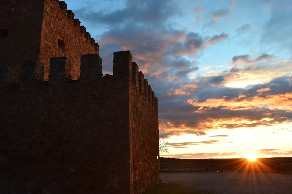 Braunes Backsteingebäude in der Nähe von Gewässern während des Sonnenuntergangs