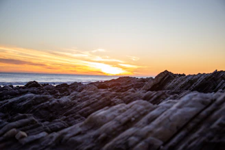 A stunning sunset view over Zadar's ancient Roman Forum with the Sea Organ in the foreground.