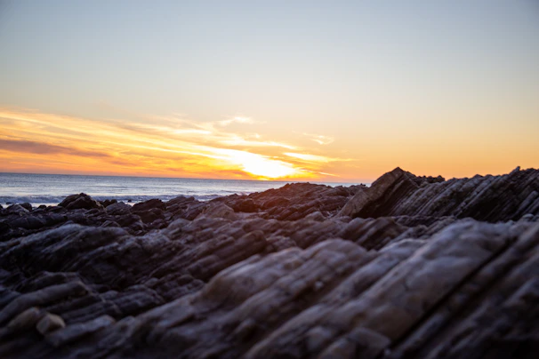 A stunning sunset view over Zadar's ancient Roman Forum with the Sea Organ in the foreground.