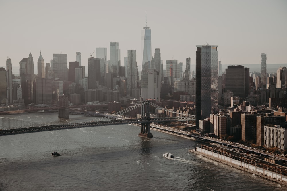 bridge over water near city buildings during daytime