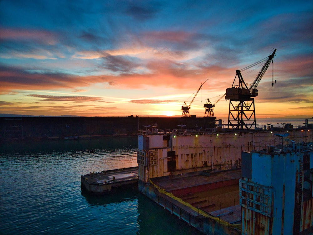 brown wooden boat on dock during sunset