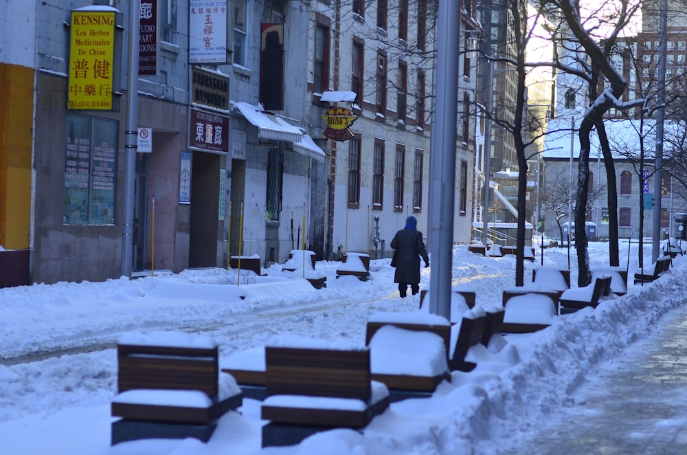 people walking on snow covered road during daytime