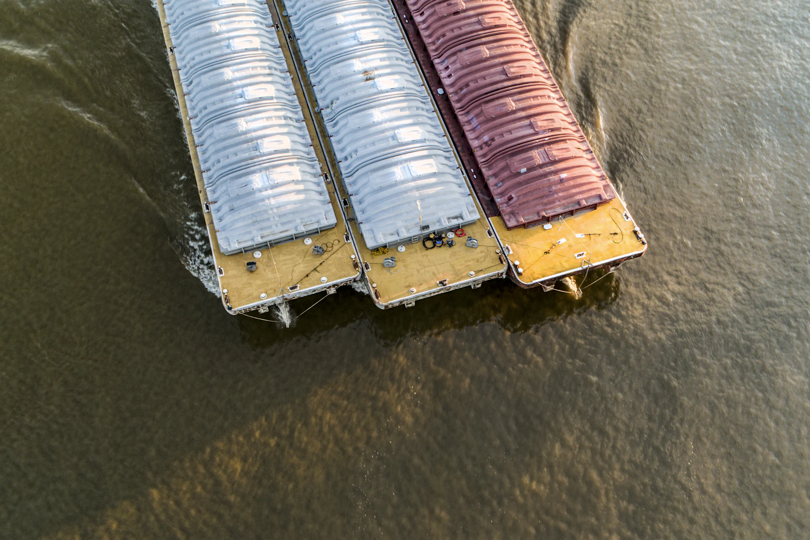 Vertical overhead view of three cargo barges positioned side by side
