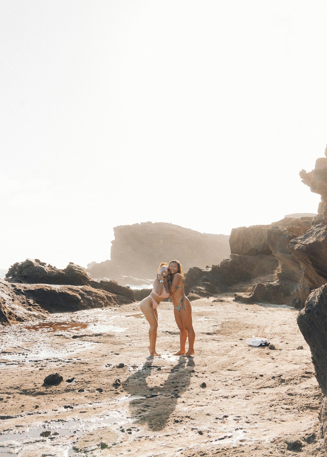 woman in black bikini walking on beach during daytime