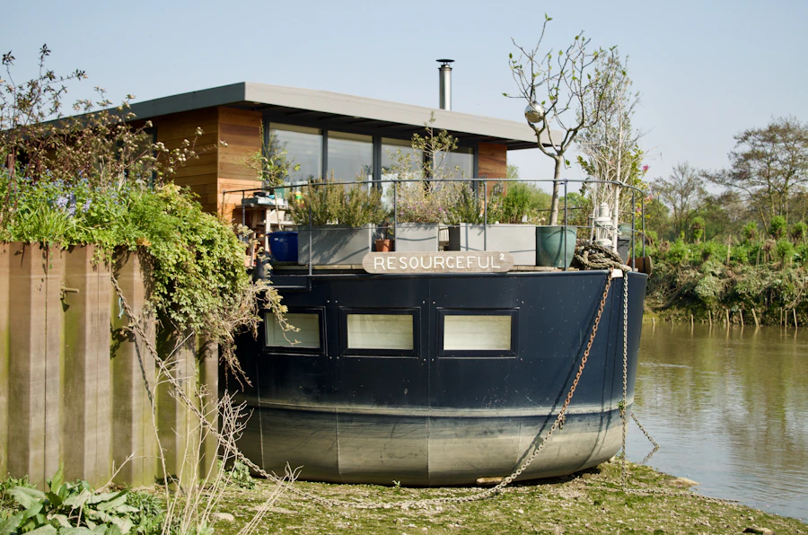 Riverbank, a timber houseboat with a railed deck moored beside green river water