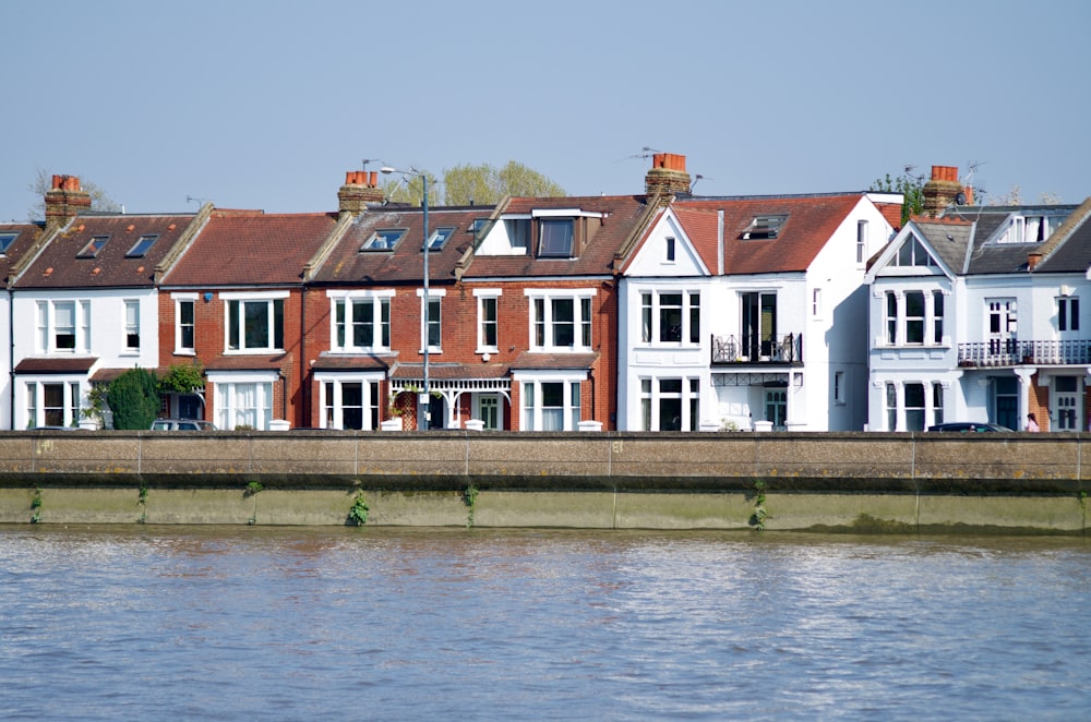 white and brown concrete building beside body of water during daytime