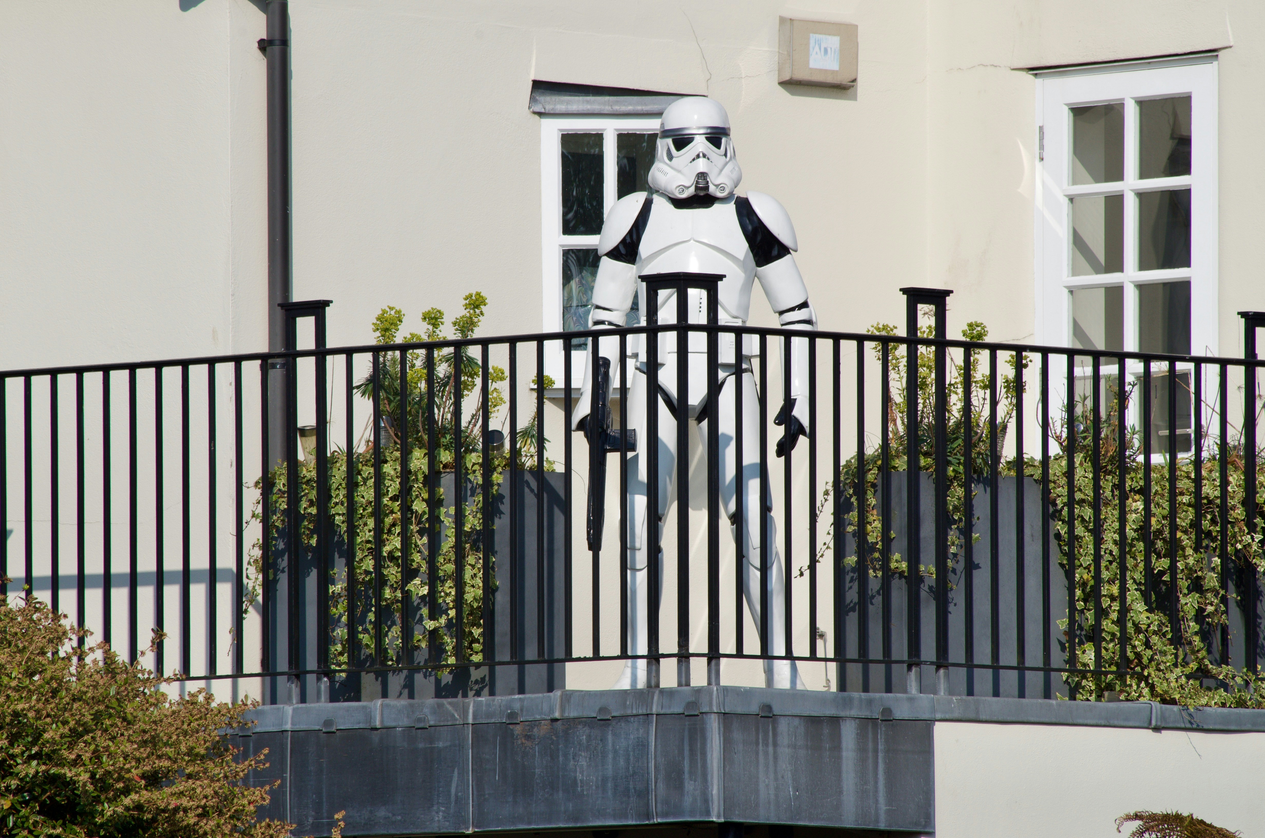 black metal fence near white concrete building during daytime