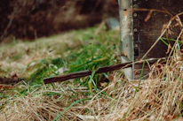 Rustic wooden beehive surrounded by wildflowers under a warm sunset sky.