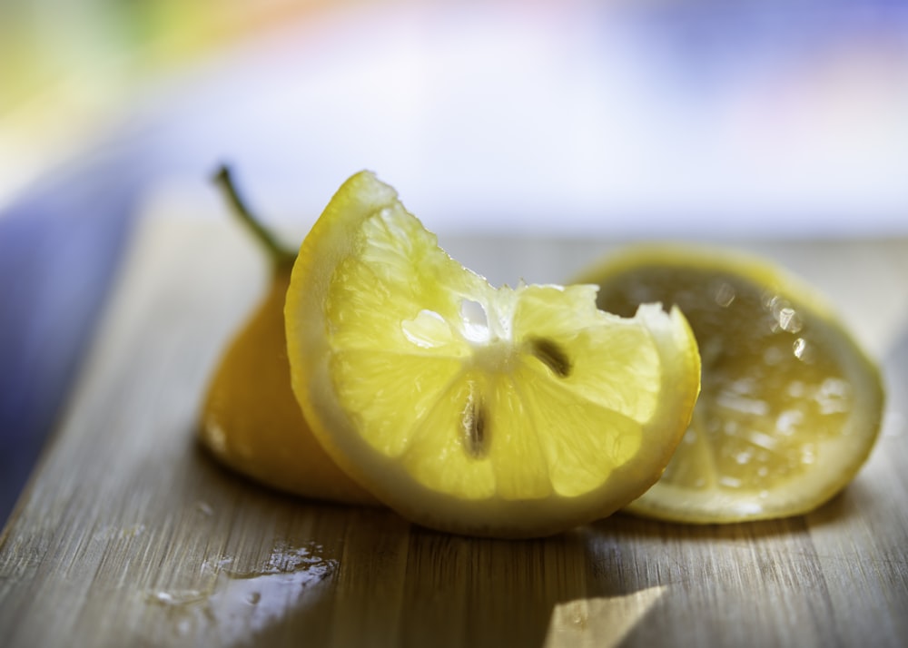 sliced lemon on brown wooden chopping board