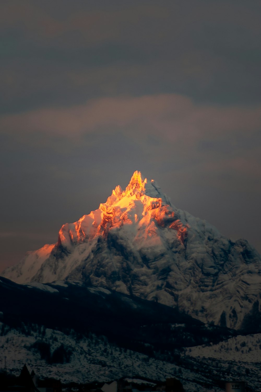 snow covered mountain under cloudy sky during daytime