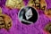 A collection of cryptocurrency coins, including Ethereum and Bitcoin, are partially buried in bright purple sand. The Ethereum coin is prominently featured at the center, while Bitcoin coins surround it.
