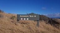 a sign that is on the side of a hill