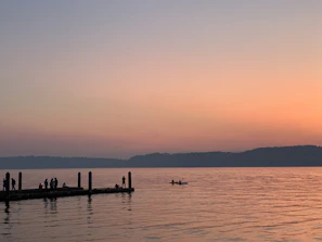 Members gathered on a dock sharing stories beside their silent electric boats at golden hour.