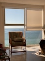 Calm therapy room with soft turquoise and green tones and a comfortable chair near a window.