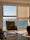 Cozy room with a window overlooking the flowing Ganges river at sunrise.