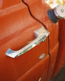 Close-up of a dented car door.