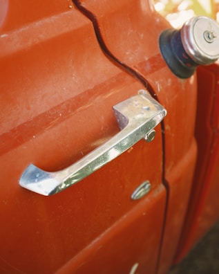 Close-up of a dented car door.