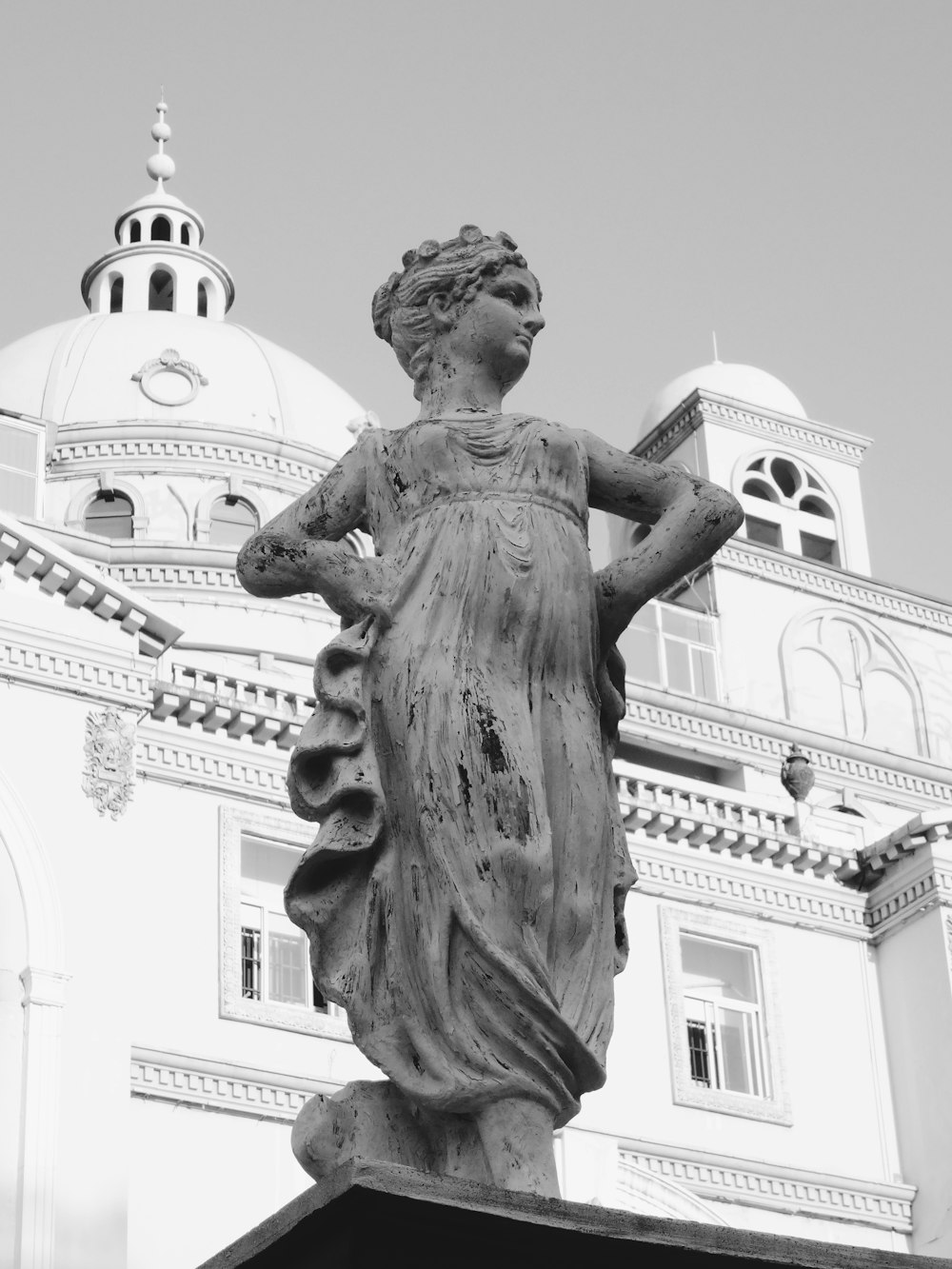 statue of man holding book