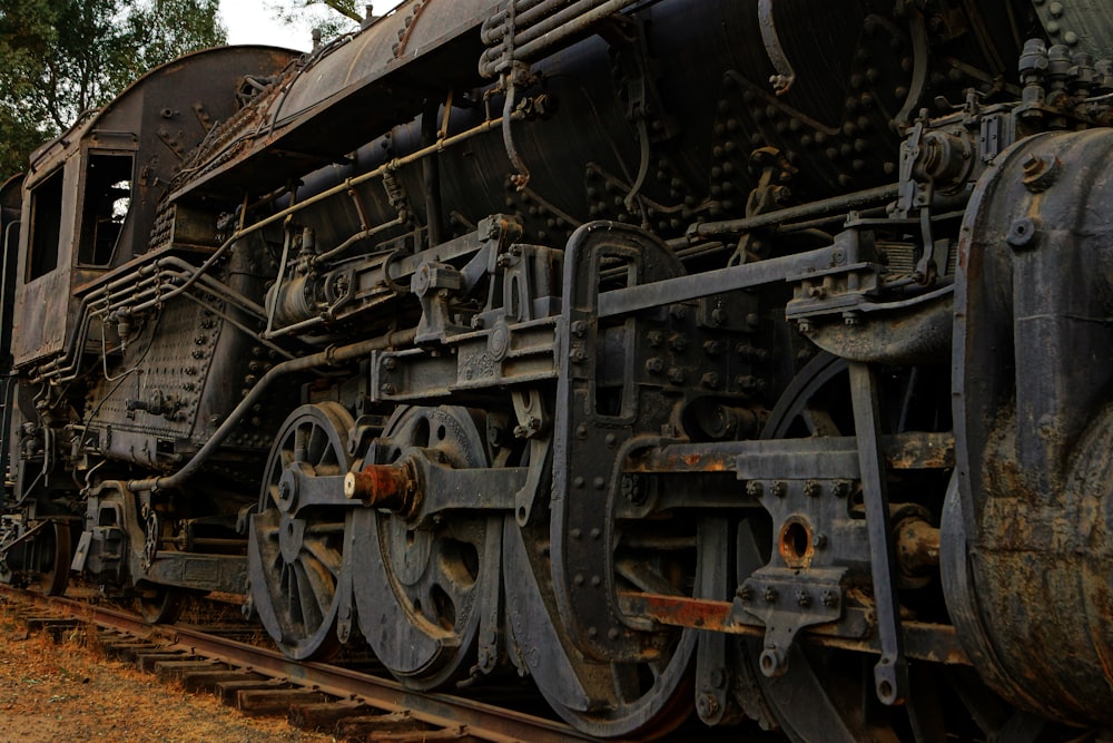 black and brown train on rail tracks during daytime