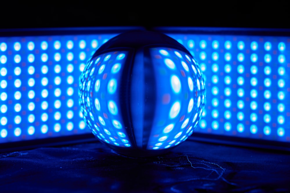 blue and white ball on black surface