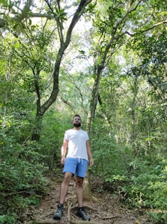 An active man hiking on a sunlit trail, showing strength and vitality.