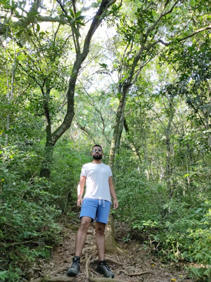 A man hiking confidently on a sunny trail, embodying vitality.