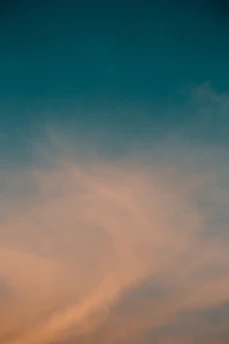 A serene violet and indigo gradient sky blending softly into a white horizon.