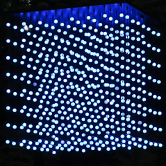 A sleek holographic cube projecting layered data streams in a dark futuristic environment.