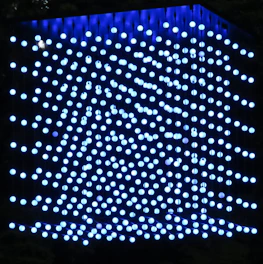 A sleek 3D lattice of interconnected cubes glowing softly in blue tones.