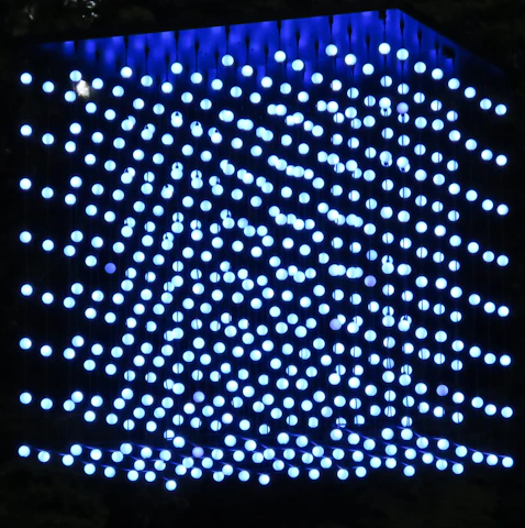 A futuristic holographic cube emitting layers of data streams in a dark, elegant environment.