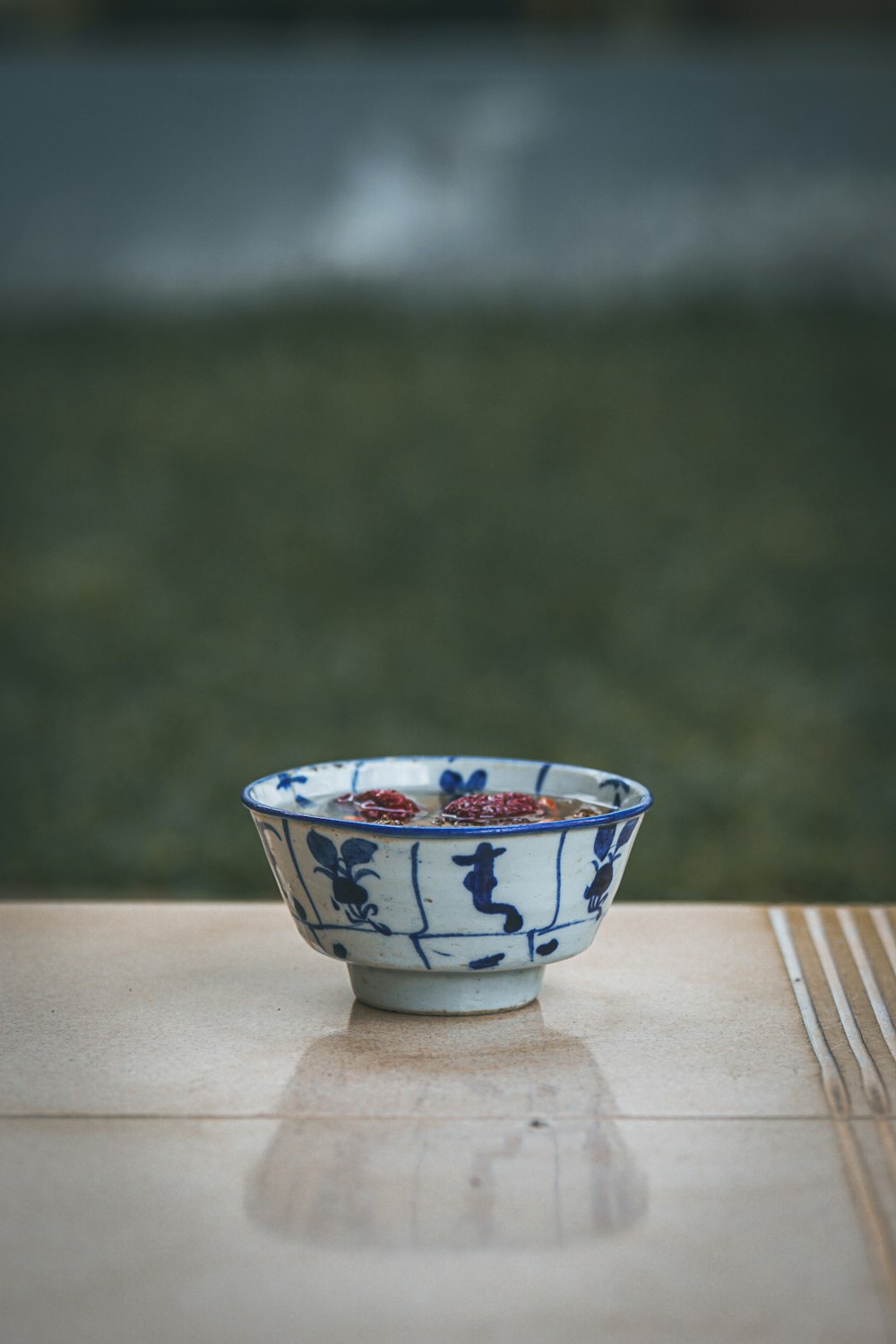 white blue and red floral ceramic bowl