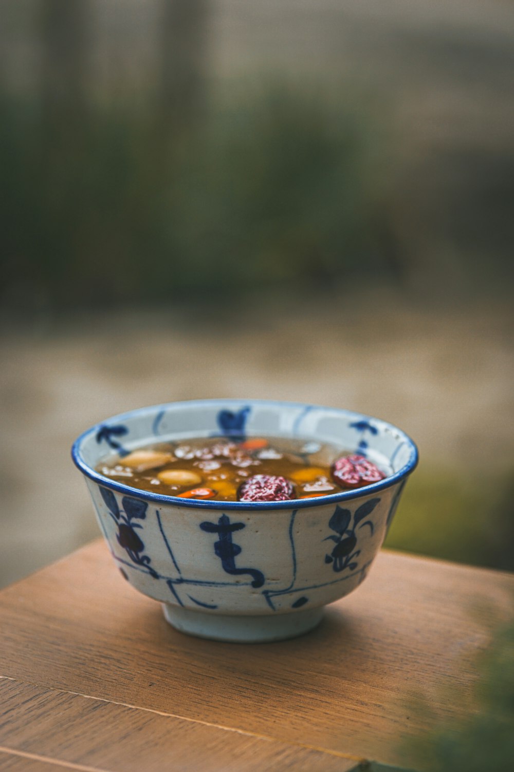 white and blue ceramic bowl with orange and yellow food