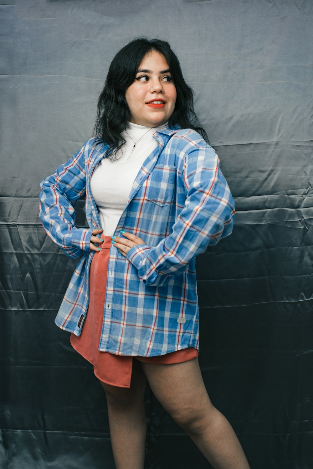 woman in white shirt and blue and white plaid coat