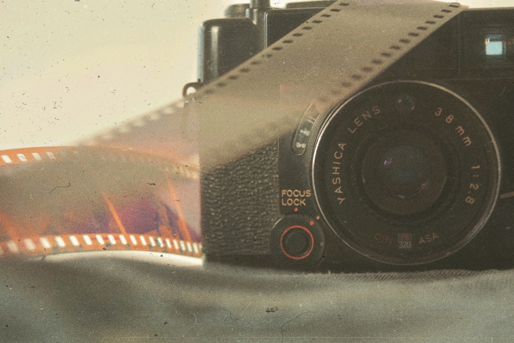 black and silver camera on white table