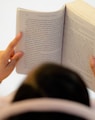 woman in white long sleeve shirt reading book