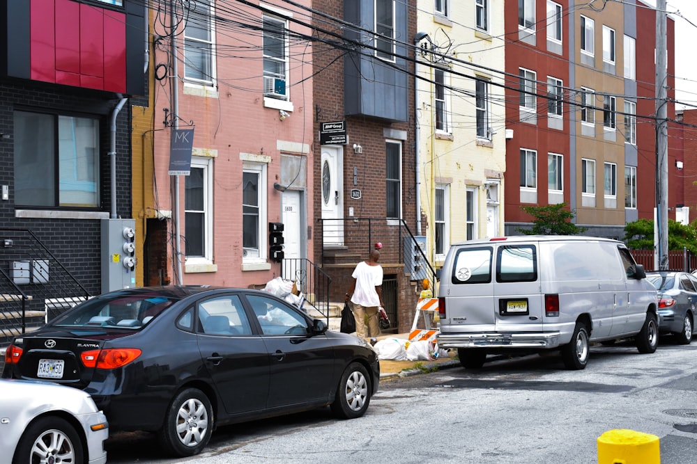 cars parked in front of brown building during daytime