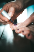 person holding white and black pen