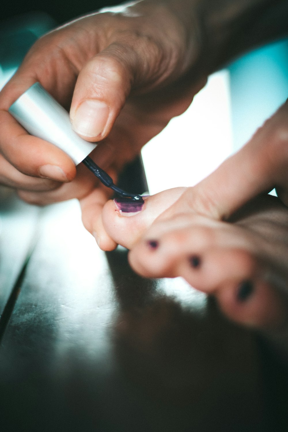 person holding white and black pen