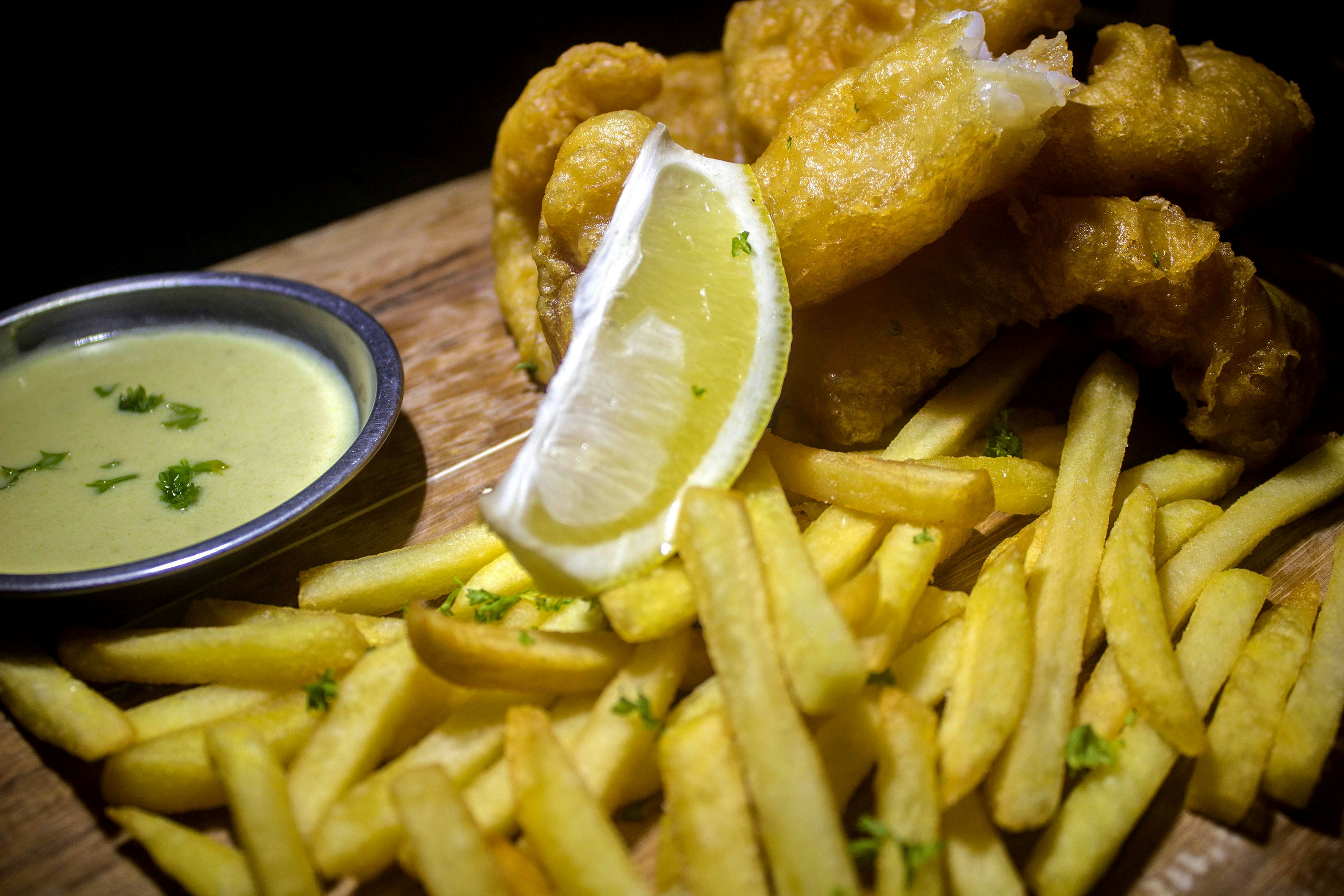 fried chicken and fries on brown wooden table