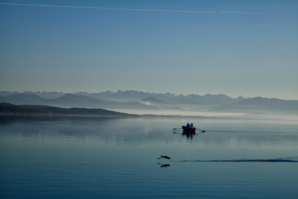 person riding on boat on body of water during daytime