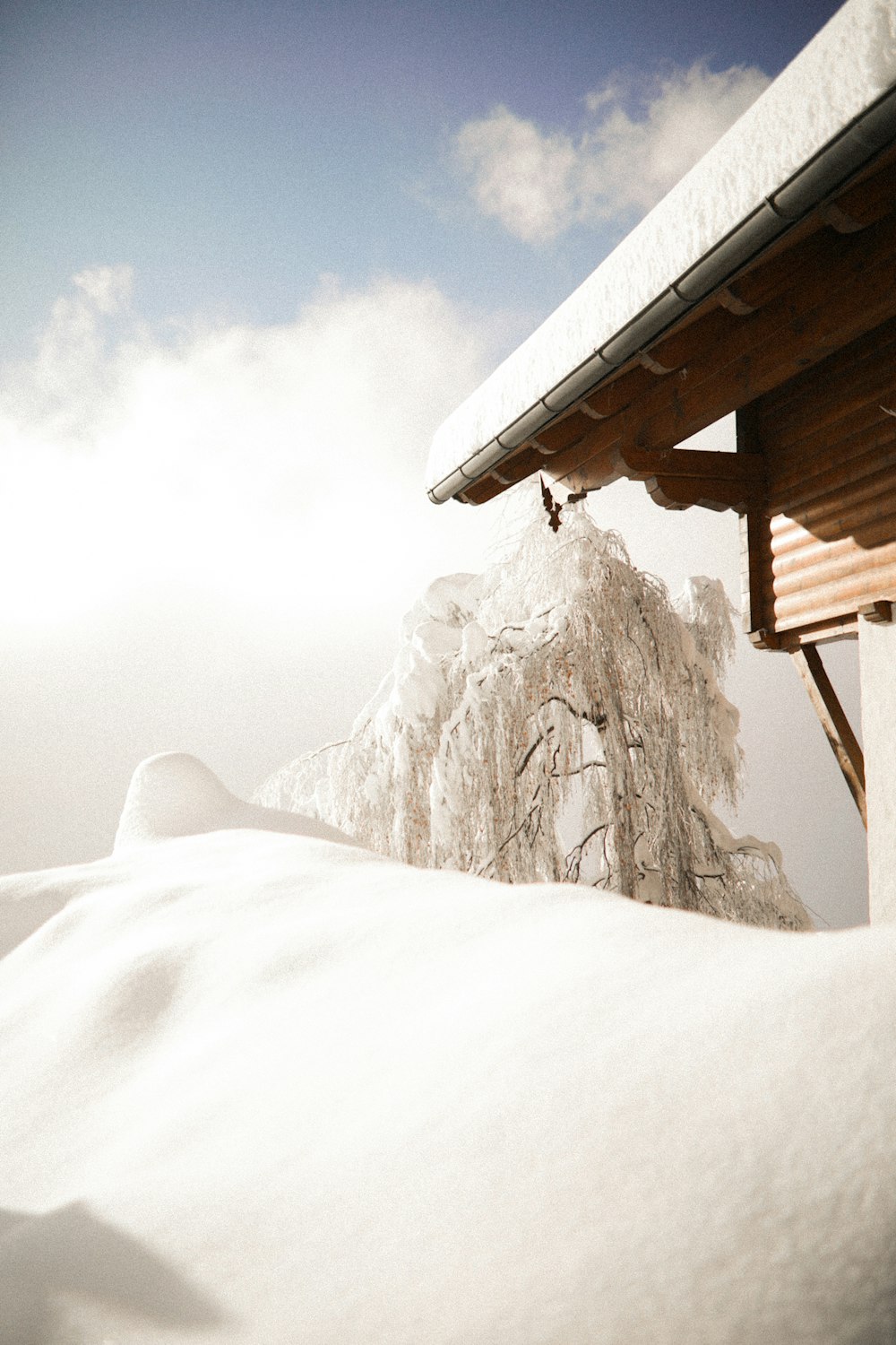 snow covered mountain under white clouds during daytime