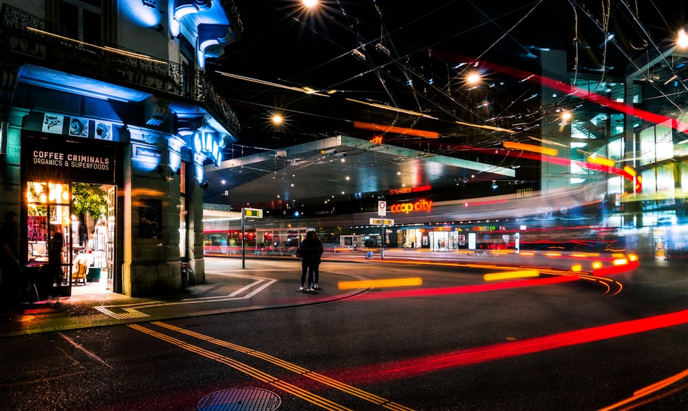 man in black jacket walking on sidewalk during night time