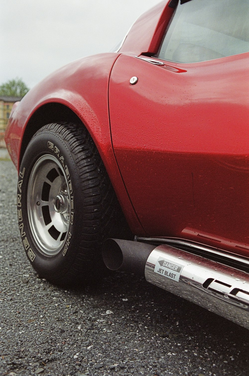 red car on gray asphalt road during daytime