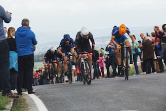 people riding bicycle on road during daytime