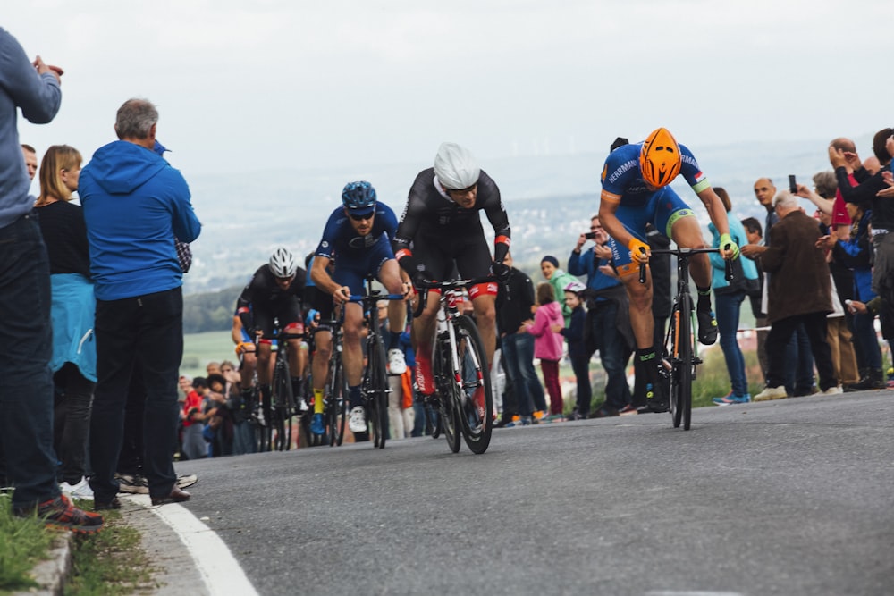 people riding bicycle on road during daytime