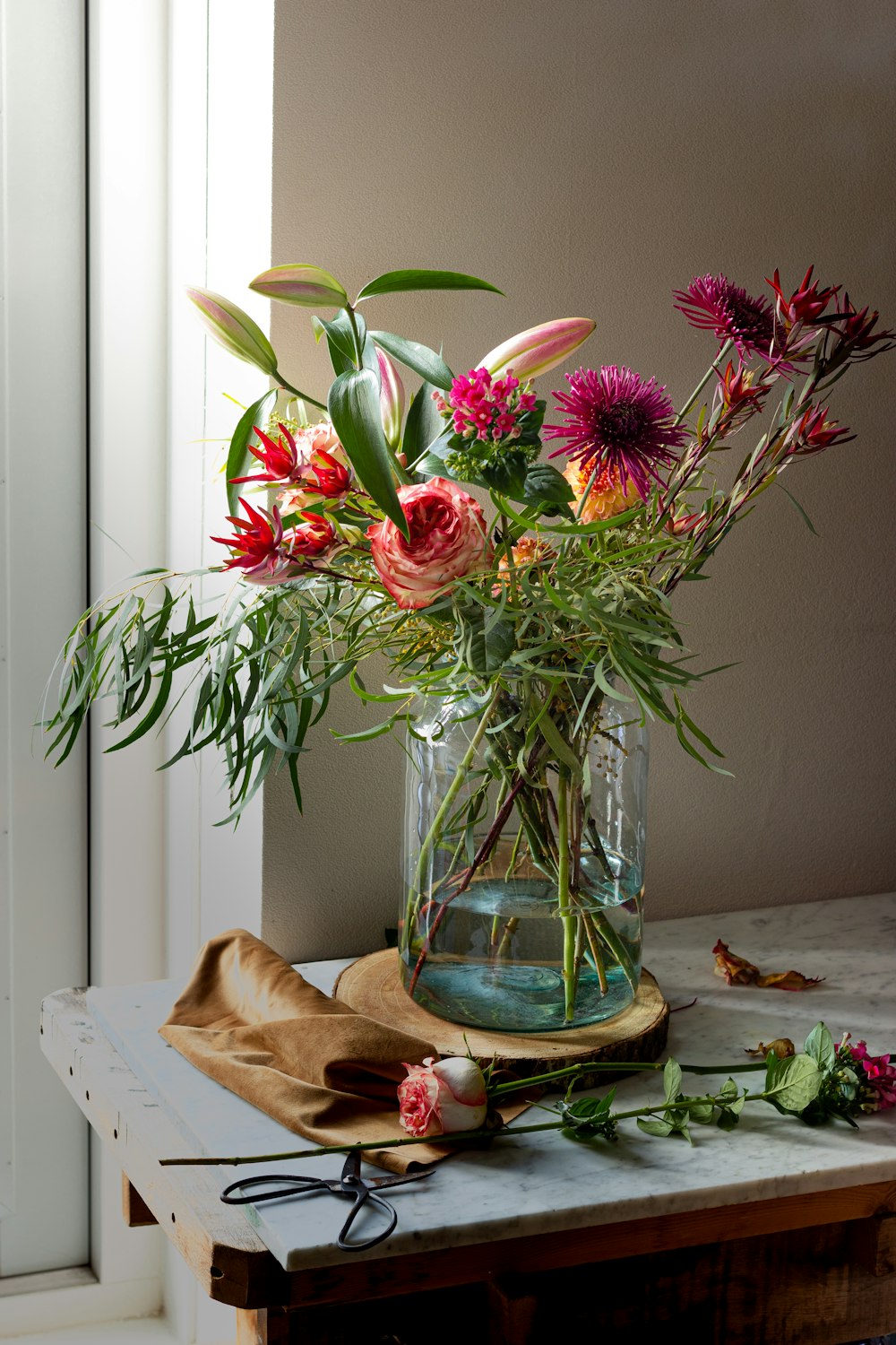 red flowers in blue glass vase