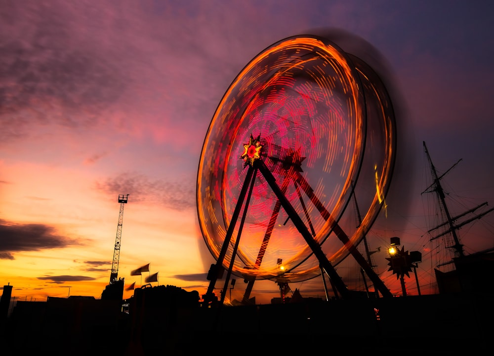 silhouette of ferris wheel during night time
